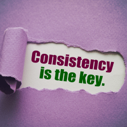 Purple page torn to reveal the phrase "Consistency is the key" behind in purple and green lettering on a white background.