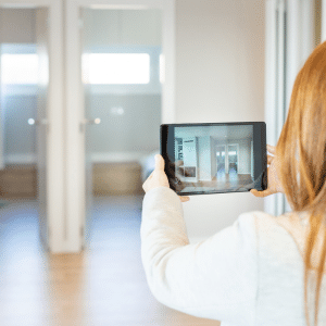 A young agent recording a virtual property tour on her tablet.