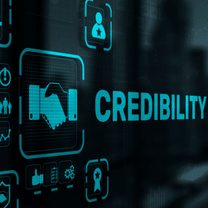 The word Credibility on a screen surrounded by icons representing the same: shaking hands, awards, reviews etc.