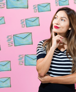 Lady looking interested on a pink background with many mails going towards her.