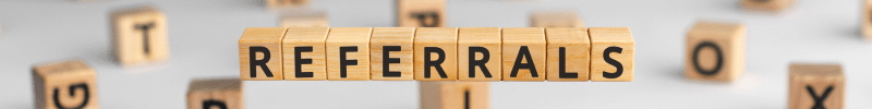 Referrals banner - spelled out in wooden block with other lettered blocks scattered in the background.
