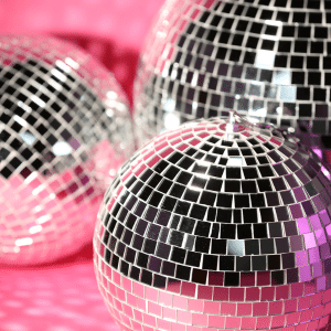 Shiny objects - 3 mirror balls on a bright pink background.