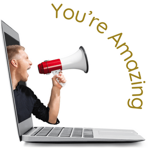 Side view of a laptop with a man leaning out of the screen with a megaphoneone in hand shouting you're amazing.
