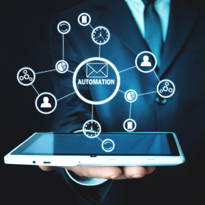 Man holding a tablet on his palm. A series of email automation icons hover above the tablet.