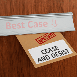 An Important stamped cease and desist notice being pushed through a letterbox with "best case" on the letter flap and an arrow pointing down.