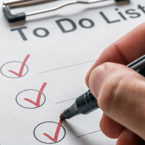 A To-Do List.
A hand marking an item off with a red check mark.