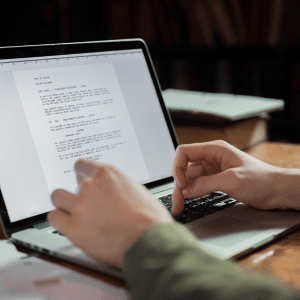 Man on a laptop creating a content outline.