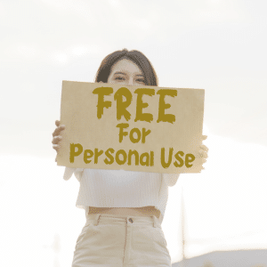 A young lady holding a sign in front of herself saying "FREE for persoanl use". Oh! The irony. This is a pro licensed image.
