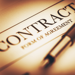 A paper Contract with 'Form of Agreement' written underneath. A fountain pen is laid on top ready for signatures of the licensed images agreement.