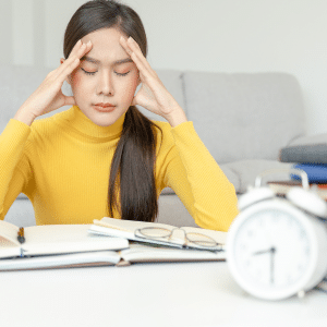 A you lady is overwhelmed by her tasks for the day. A clock in front of her is showing 8:30 AM.