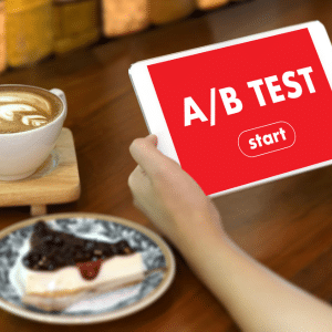 Unseen lady holding a tablet with A/B Test on the screen and a start button below.