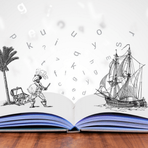 Close-up of a book opened on a desk. A pencil drawn pirate with a chest and palm tree is on one page and a drawn pirate ship in the ocean pops out of the other. Random letters are floating in between the images. 
Represents words bringing the story to life.