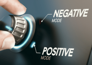 A knob on a panel being switched from negative mode to positive mode.